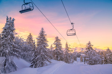 Winter mountains panorama with ski slopes and ski lifts - 99925882