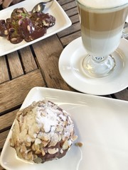chocolate cake and coffee on table at cafe