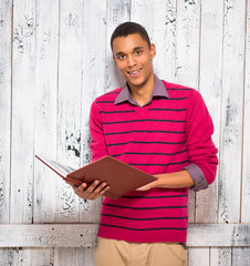 Obraz premium Handsome man with register or journal in studio