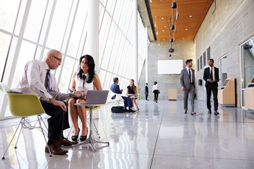 Business Meetings In Busy Office Foyer Area