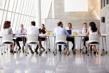 Group Business Meeting Around Table In Modern Office