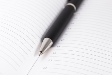 Ball pen and office pad, focus on the tip