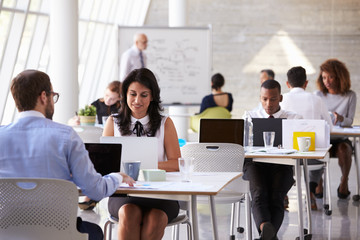 Businesspeople Working At Desks In Modern Office