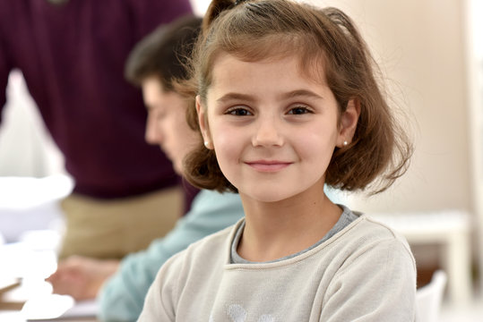 Portrait of smiling school girl in class