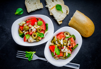 Fresh salad with tomatoes, lamb's lettuce, olives and onion