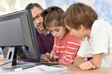 Teacher with kids in computing class