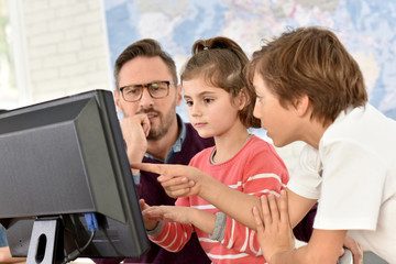 Teacher with kids in computing class