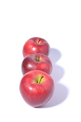 Red ripe apples on white background.