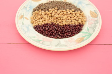 plate of various vegetables on pink background
