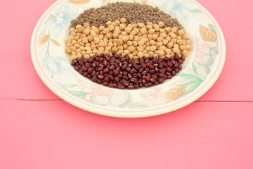 plate of various vegetables on pink background
