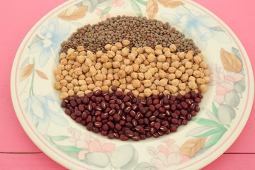 plate of various vegetables on pink background

