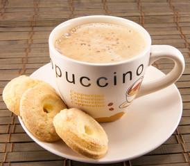 cup of cappuccino and cookies