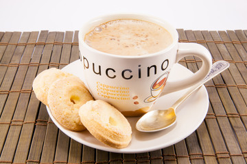 cup of cappuccino and cookies