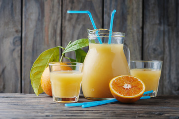Healthy fresh orange juice on the woodent table