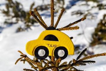 Toy car taxi hang on the fir tree