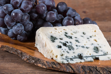 French roquefort cheese with black grapes