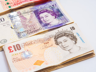 Bundle of pound currency on white