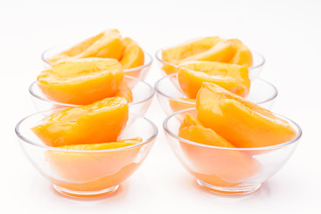 Fototapeta na wymiar Cut peaches in syrup isolated on white