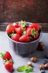 Strawberries and Blueberries on metal background