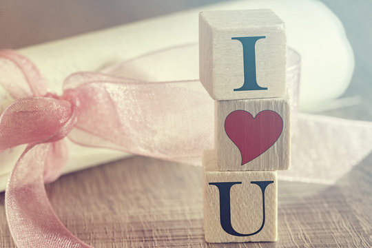 I Love You message formed with wooden blocks on a red heart
