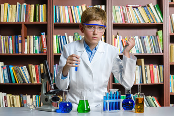 Cute boy doing biochemistry research in chemistry class