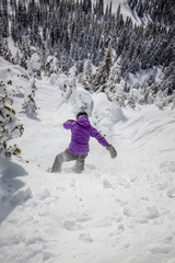 Fototapeta na wymiar Young Woman Snowboarder on Steep Terrain