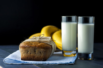 Banana bread, glasses of milk on burlap napkin
