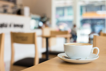 Hot art Latte Coffee in a cup on wooden table