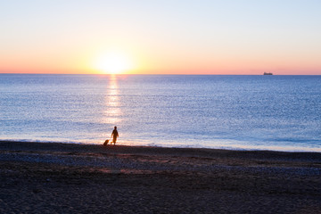 Person traveling Woman walking on Ocean Beach at Sunrise