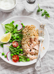 Baked salmon with lemon grain crust and fresh vegetable salad with peas, spinach, radishes and cherry tomatoes. Delicious healthy dinner