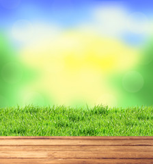 Fototapeta na wymiar wooden table, blurred nature background and green grass