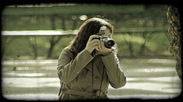 Woman takes picture. Vintage stylized video clip.