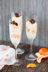 Raw vegan dessert in a glass with cashew nuts and oranges