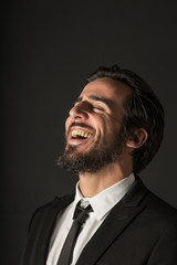 Business man on black bacgroung laughing