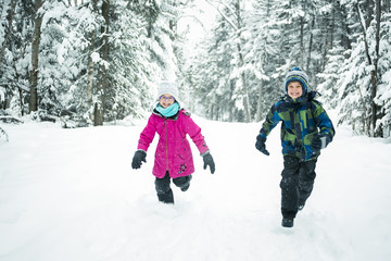Little girl and boy in winter season