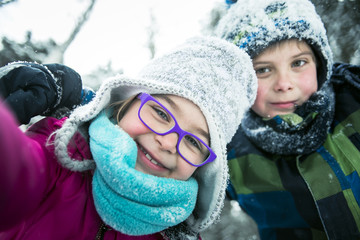 Little girl and boy in winter season