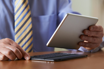 Businessman Using Digital Tablet With Detachable Keyboard