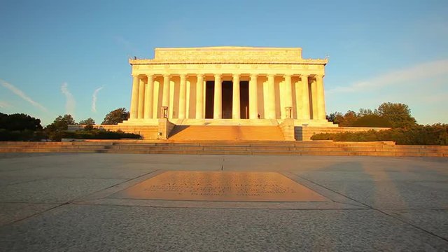A tracking shot of the exterior of the Lincoln Memorial at dusk in Washington DC.
