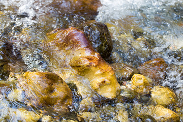 colored stones under water as background