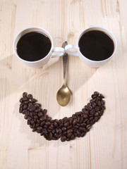 Coffee beans and a white cup on table