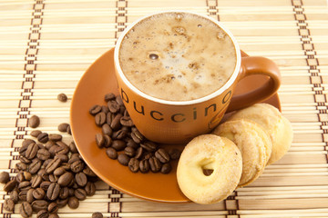 cup of cappuccino and cookies
