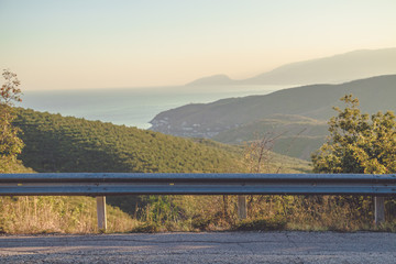 Guardrail with mountain and sea background
in summertime