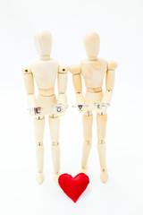 loving couple holding the word love with their hands and their hearts to their feet