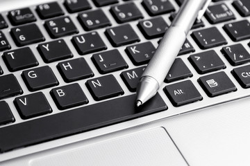 silver pen on computer laptop