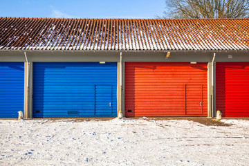 blue and red Garage Doors in Snow