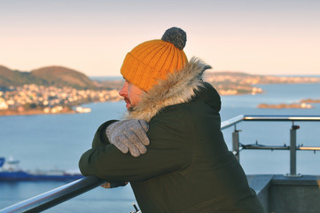 Young man looking at the Atlantic ocean in Norway - Alesund