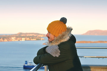 Young man looking at the Atlantic ocean in Norway - Alesund