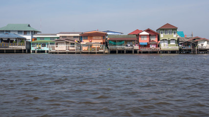 Traditional stilt houses on Chao Phraya's riverbank