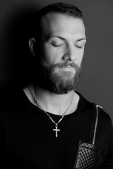 Black and white portrait of cool man praying and meditating