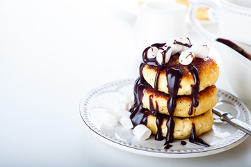 Syrniki cheese pancakes with sour cream 